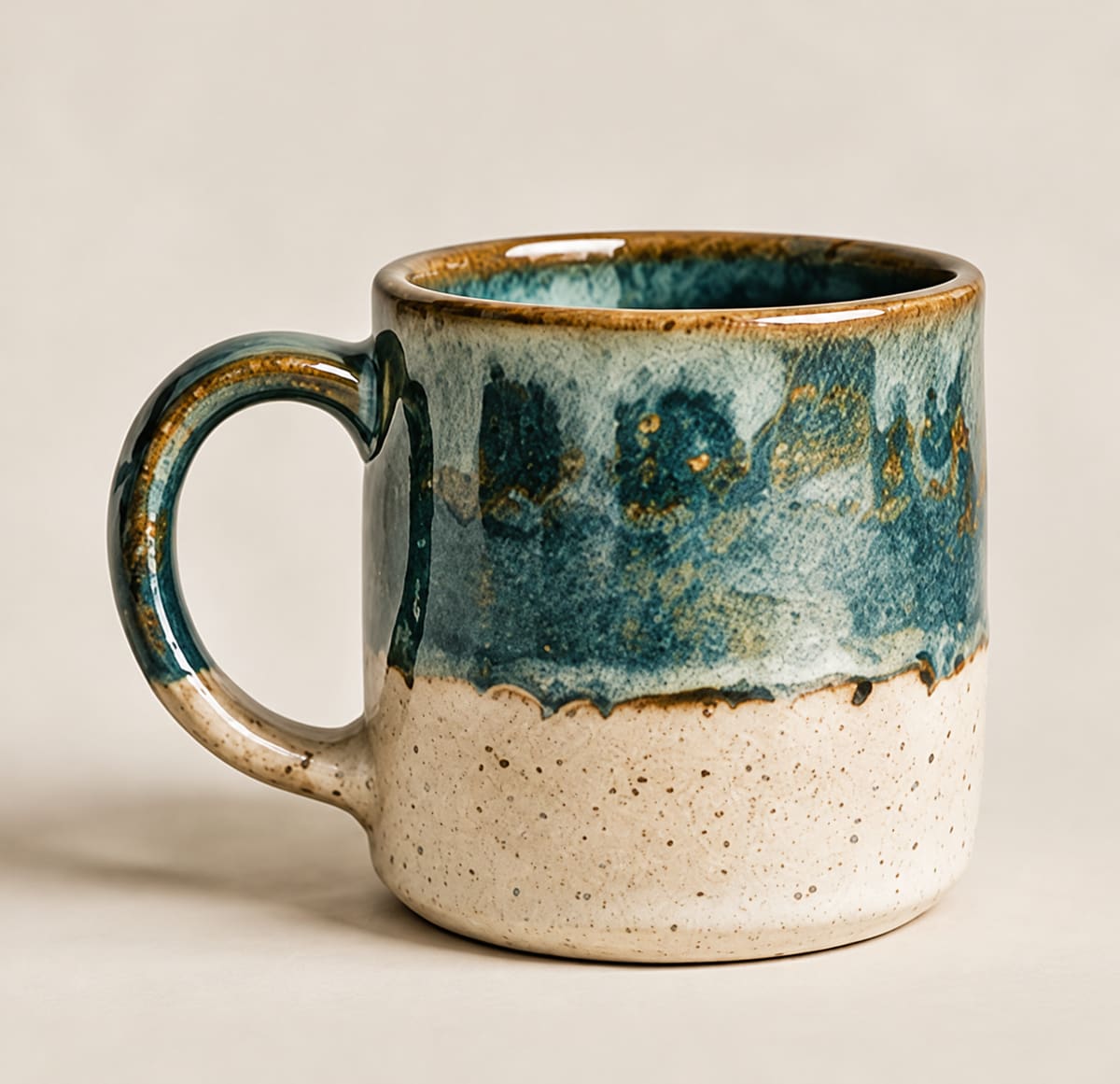 Handmade mug with a pooled teal glaze over speckled ivory clay
